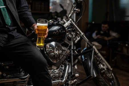 Motorcyclist holding a beer